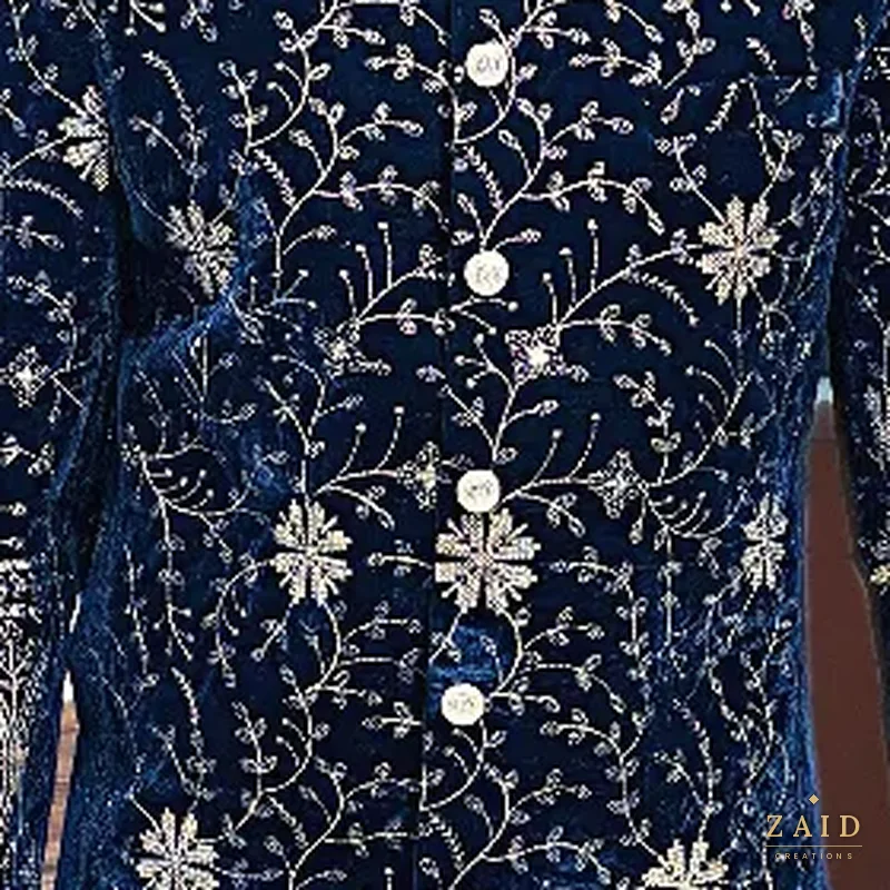 Close-up of gold vine embroidery on navy velvet